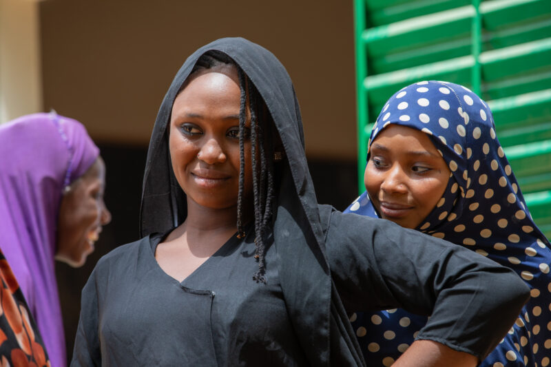 Students Outside their New School — Happy Student stand outside their new school provided by ADRA Norway — Adult, Africa, Education, Eyes Open, Fashion Show