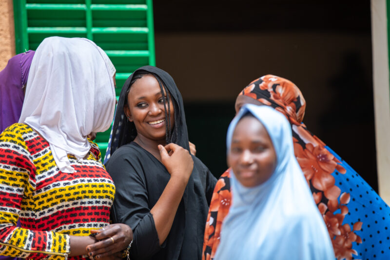 Students Outside their New School — Happy Student stand outside their new school provided by ADRA Norway — Adult, Africa, Education, Eyes Open, Female