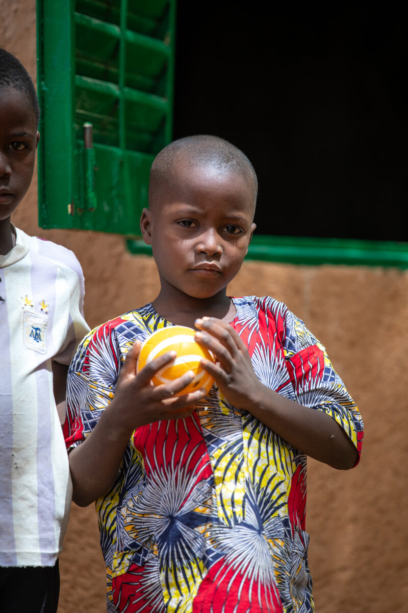 Students Outside their New School — Happy Student stand outside their new school provided by ADRA Norway — Africa, Ball Game, Child, Education, Eyes Open