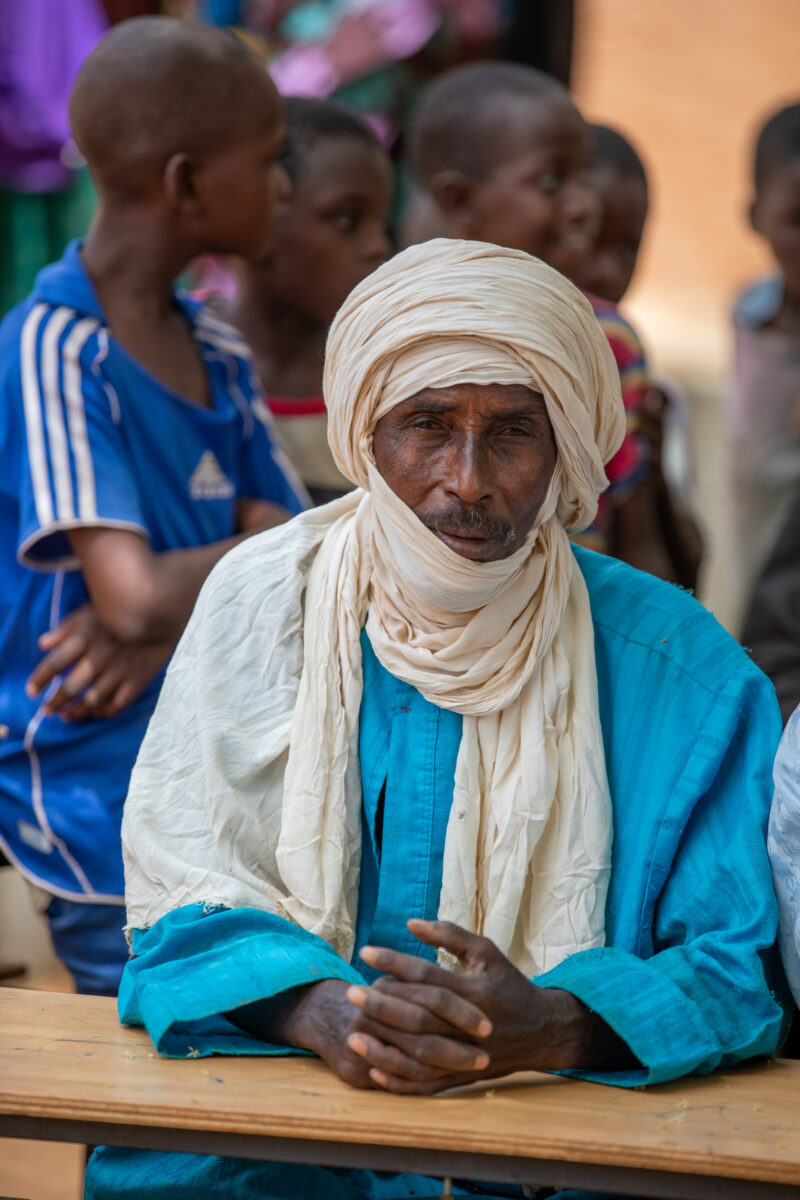 Parents Attend Meeting — Parents in Rural Niger attend a parrent teacher meeting. — Adult, Africa, Beard, Complementary Colors, Education