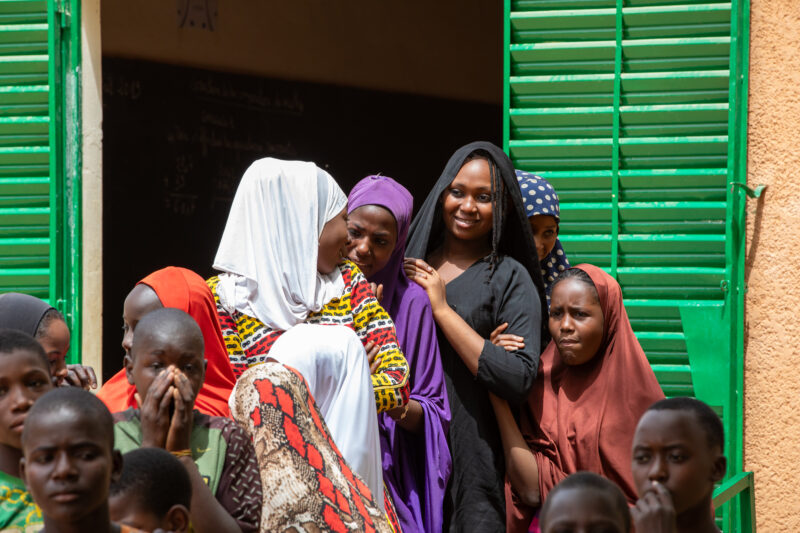 Students Outside their New School — Happy Student stand outside their new school provided by ADRA Norway — Adult, Africa, Complementary Colors, Education, Ey...