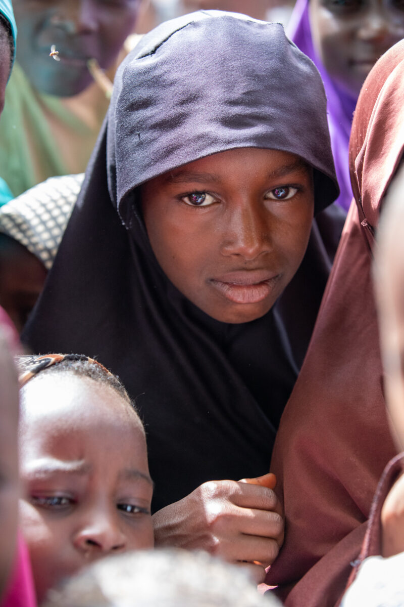 Students Outside their New School — Happy Student stand outside their new school provided by ADRA Norway — Adult, Africa, Black Hair, Education, Eyes Open