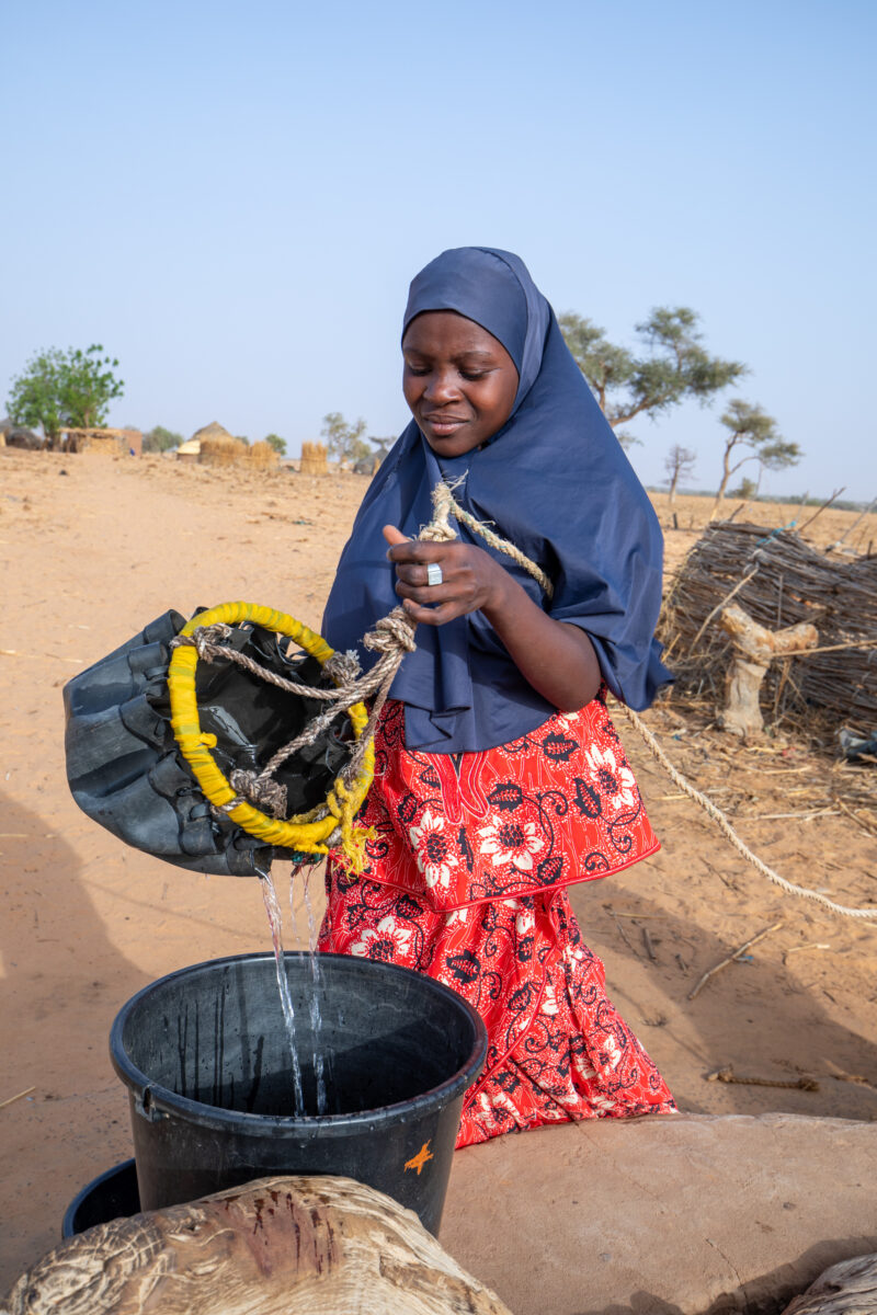 Collecting Water in Niger — A daily task in many regions of rural Africa is the trip to a water source to collect water. — Africa, Education, Eyes Closed, Fe...