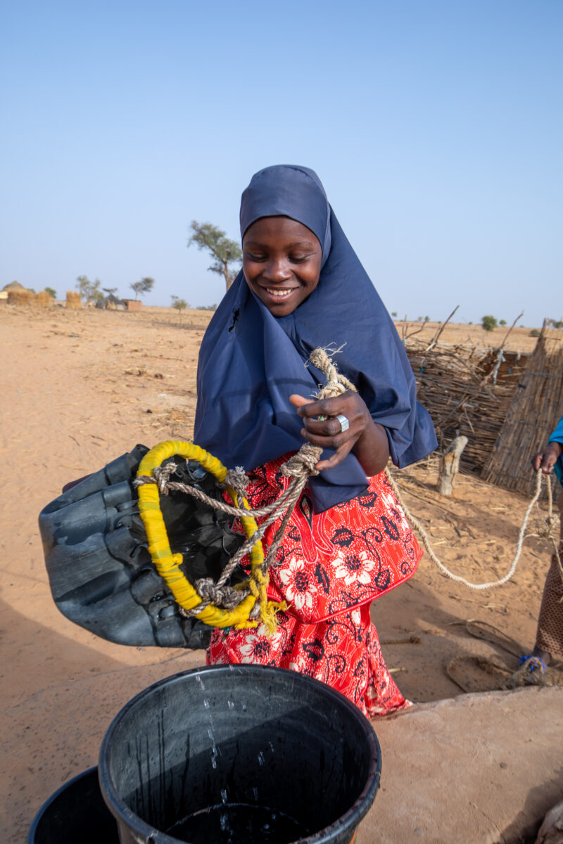 Collecting Water in Niger — A daily task in many regions of rural Africa is the trip to a water source to collect water. — Africa, Child, Education, Eyes Clo...