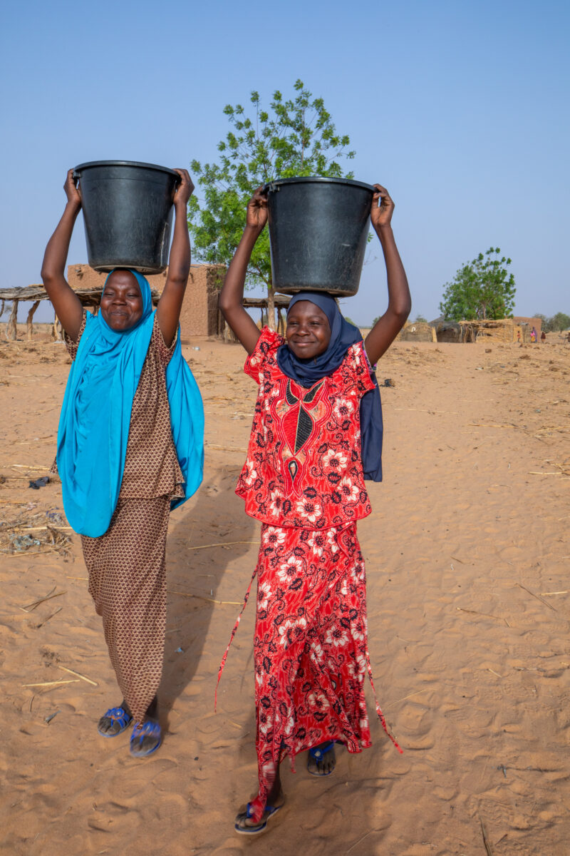 Collecting Water in Niger — A daily task in many regions of rural Africa is the trip to a water source to collect water. — Adult, Africa, Beard, Education, E...