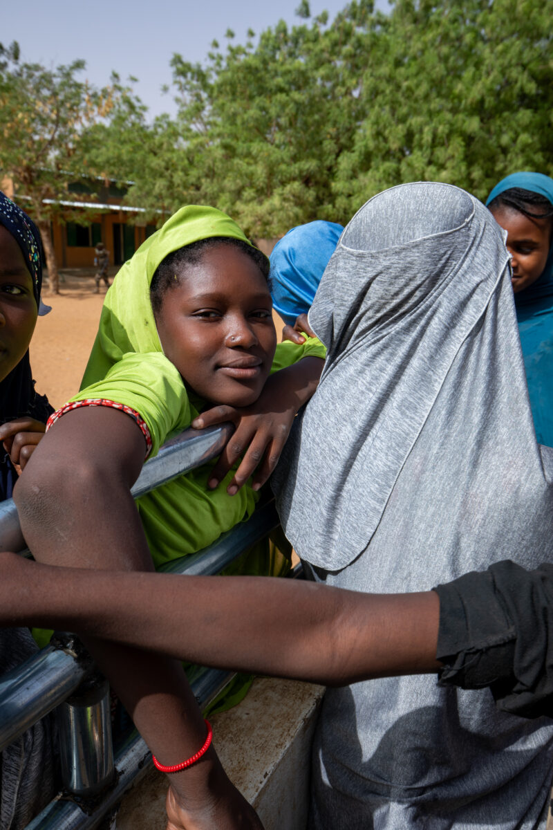 At the School Well — Students get a refreshing drink at a well at their school provided by ADRA — Africa, Boat, Child, Education, Eyes Open