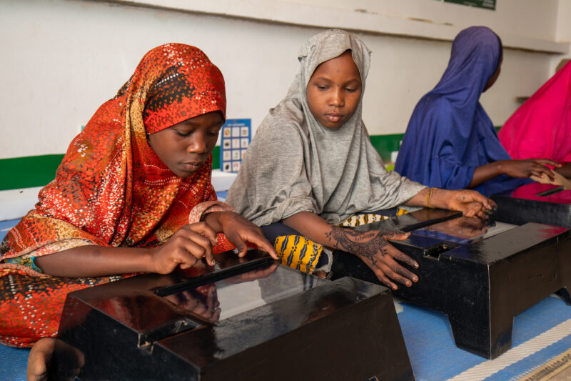 Computer Class in Niger — Young students in Niger learn computer skills on tablets provided to their school by Norway. — Africa, Child, Education, Female, Fr...