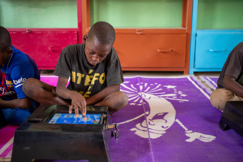 Computer Class in Niger — Young students in Niger learn computer skills on tablets provided to their school by Norway. — Africa, Child, Complementary Colors,...