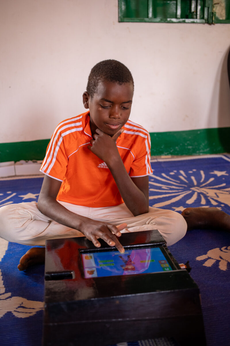 Computer Class in Niger — Young students in Niger learn computer skills on tablets provided to their school by Norway. — Africa, Child, Education, Eyes Close...