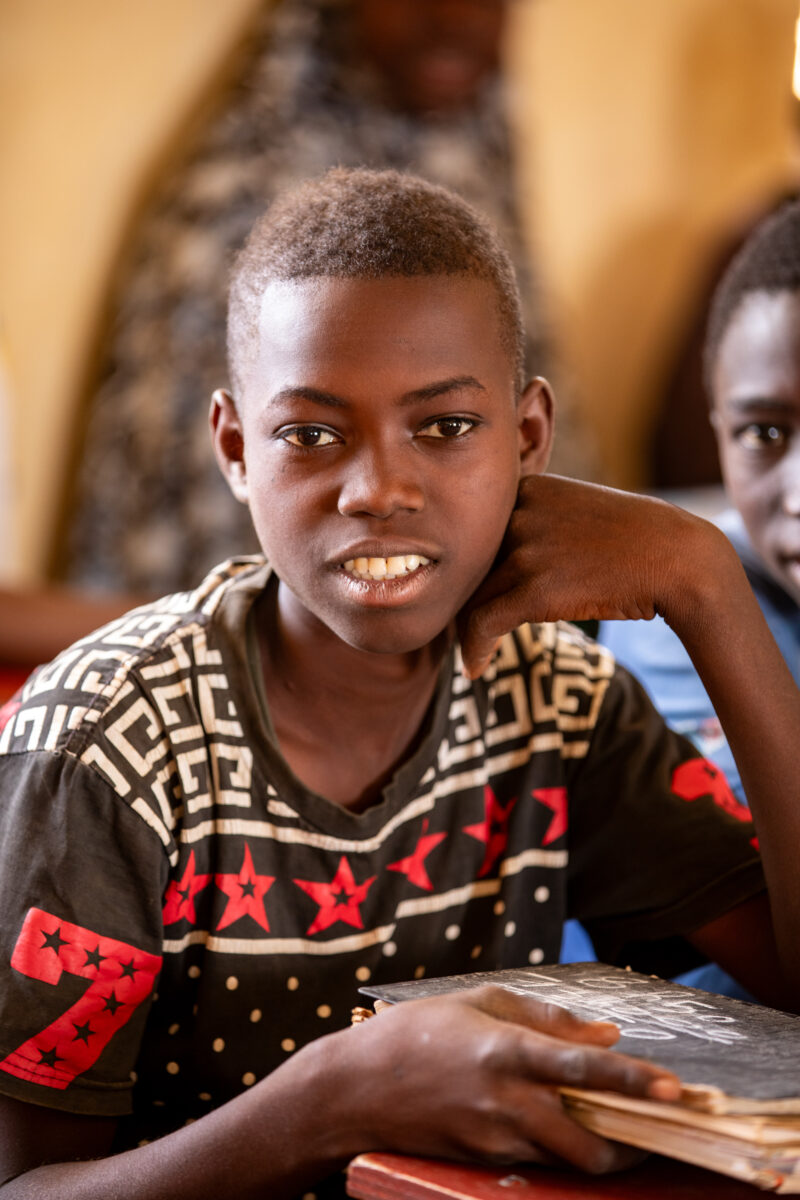 Boy in School in Niger — Young boy attends school in Niger, Africa — Africa, Close-Up, Education, Eyes Open, Frontal Face