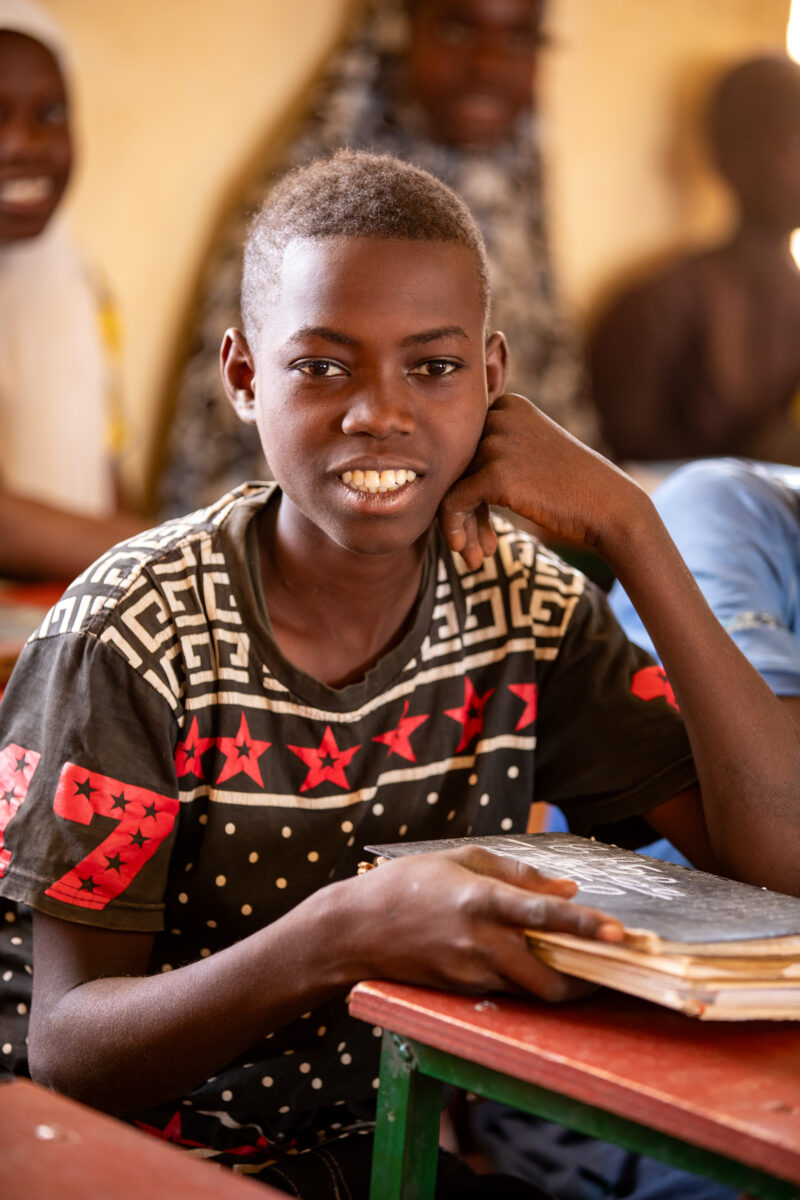 Boy in School in Niger — Young boy attends school in Niger, Africa — Africa, Close-Up, Education, Eyes Open, Frontal Face