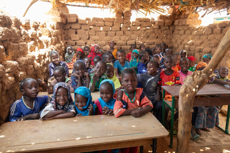 Temporary Classroom — Students in Niger, Africa, attend school in a classroom made of mud and sticks. — Adult, Africa, Beard, Child, Education