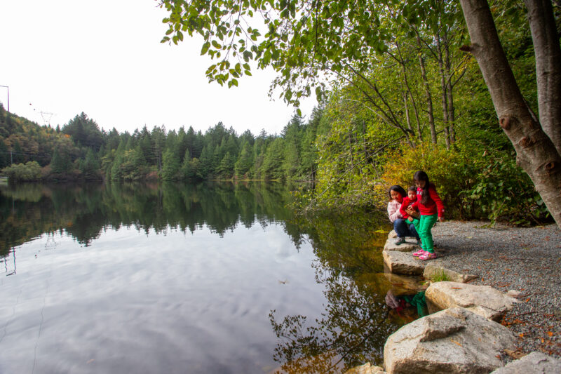 Scenic Lake — Mother and her two young children enjoy a scenoc lake in British Columbia, CanaDA — Boat, Child, Eyes Open, Forest, Frontal Face