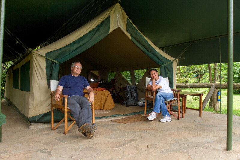 On Safari — Couple relax at their Safari tent accomodations — Adult, Architecture, Eyes Closed, Eyes Open, Female
