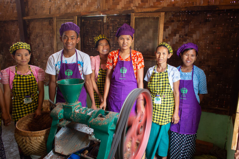 Income Group — People in Rural Myanmar learn how to make peanutbutter as a way to create income. — Adult, Eyes Open, Female, Frontal Face, Group