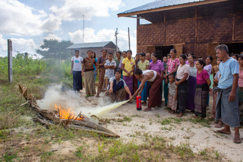 Fire Safety — Community group learns how to use a fire extinguisher — Adult, Child, Eyes Closed, Eyes Open, Female