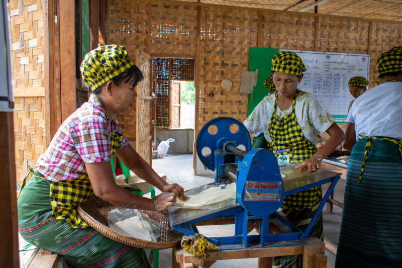 Community Income Group — People in rural Myanmar learn new ways to make income through food processing. — Adult, Eyes Closed, Frontal Face, Male, Person