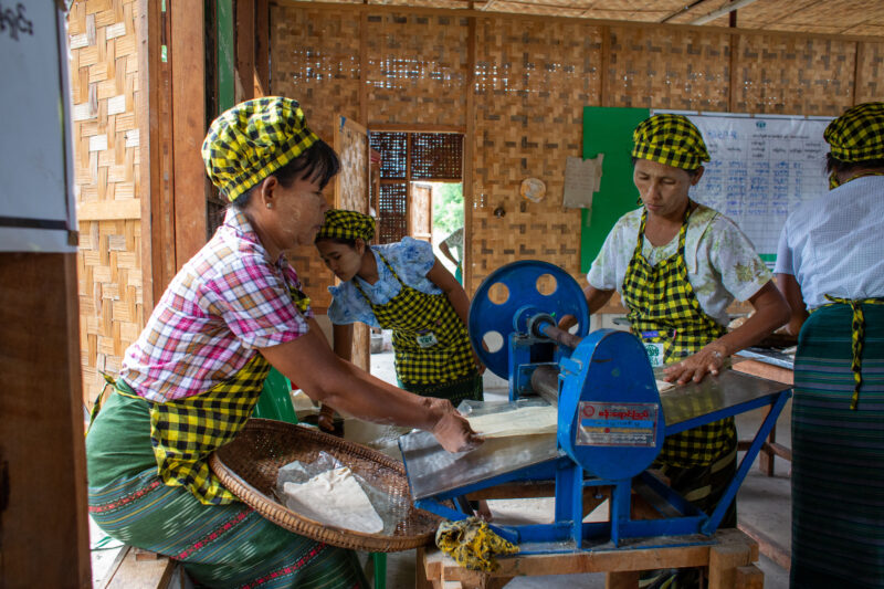 Community Income Group — People in rural Myanmar learn new ways to make income through food processing. — Adult, Eyes Closed, Frontal Face, Group, Male
