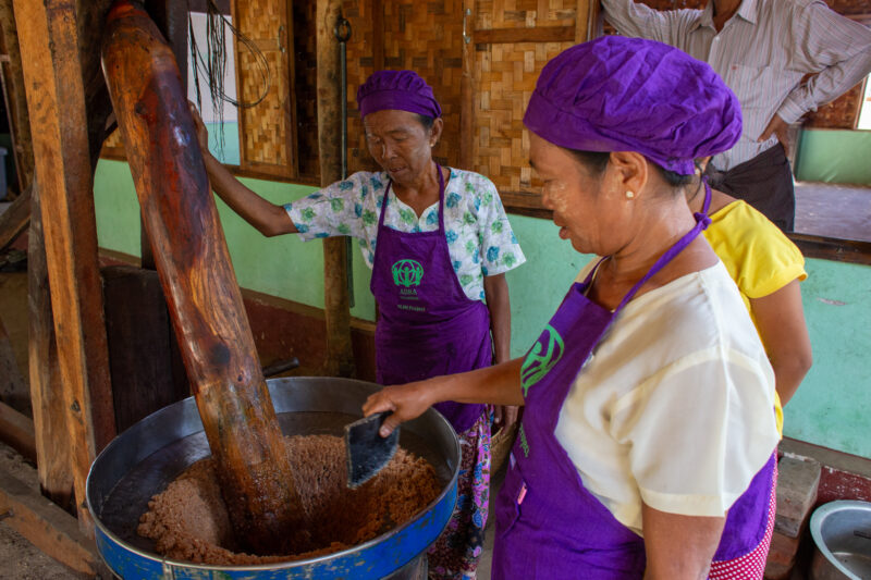 Peanut Butter Grinding — People in rural Myanmar learn new ways to make income through food processing. — Adult, Eyes Closed, Frontal Face, Male, Person