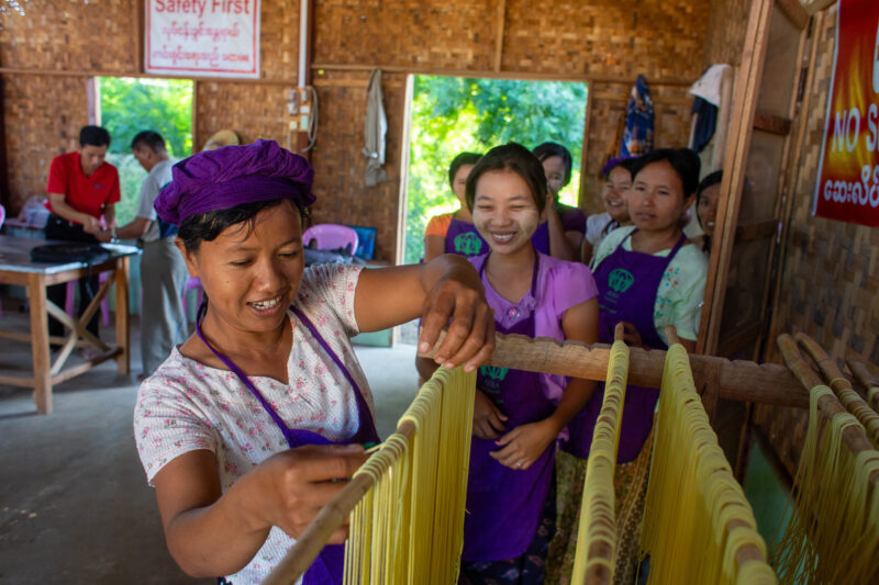 Making Spaghetti — Community income group learn how to make spaghetti as a new way to make income. — Adult, Architecture, Building, Eyes Closed, Eyes Open