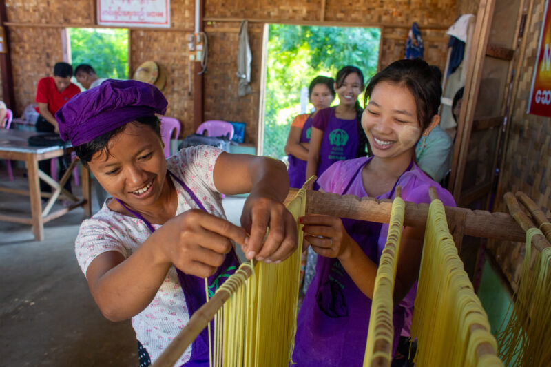 Making Spaghetti — Community income group learn how to make spaghetti as a new way to make income. — Adult, Child, Eyes Closed, Eyes Open, Female