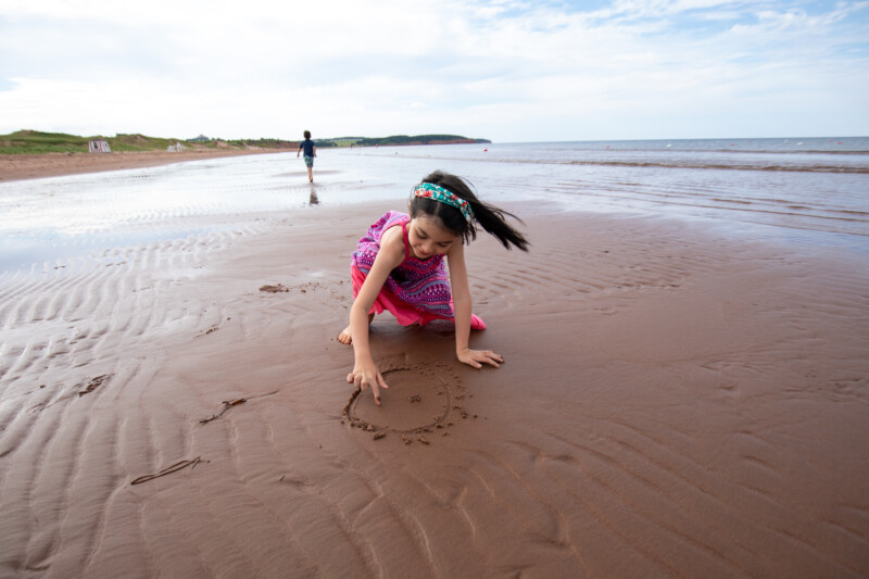 Playing at the Beach — With the tide out in the shallow shorelines of Prince Edward Island, the sandbars stretch out for miles! — Prince Edward Island, Canad...