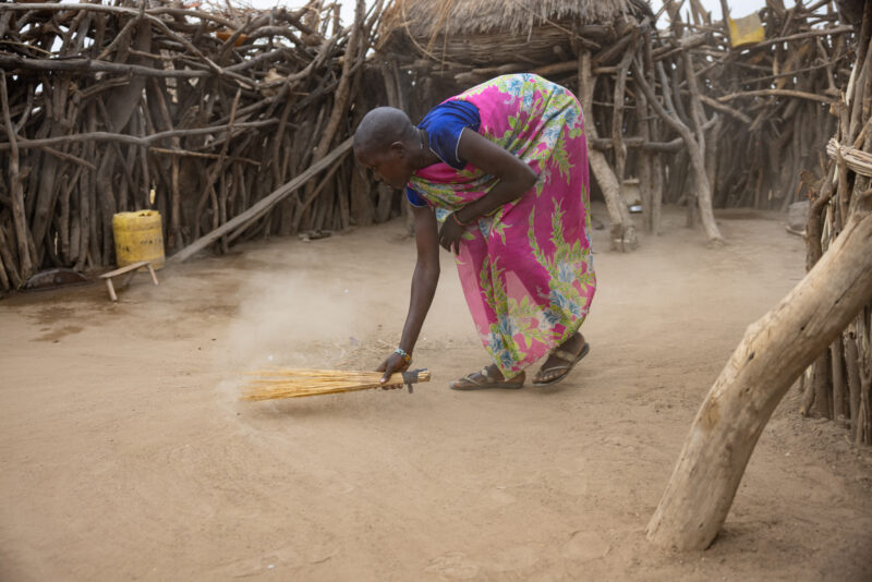 Sweeping the Compound — Girl in South Sudan sweeps the compound of her family as a morning chore every day. — One Face, Person, Profile Face, South Sudan, Af...