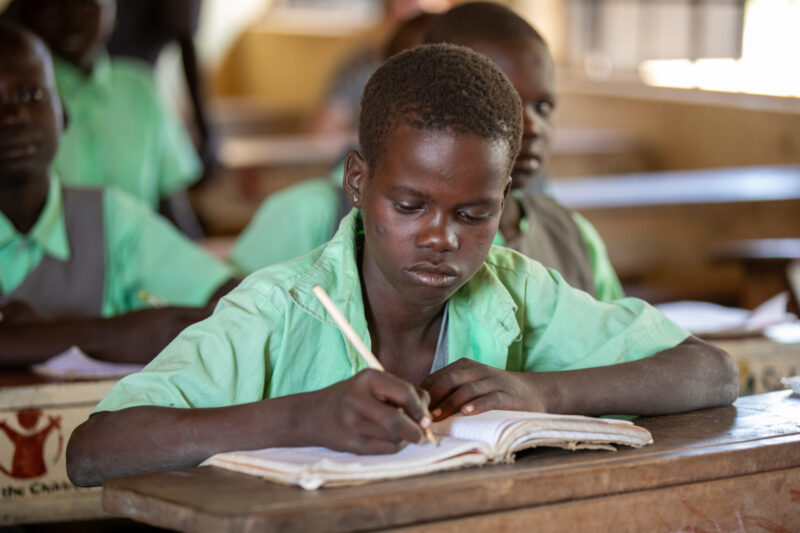 Happy to Be In School — Youn girls in South Sudan Africa are going back to school — Child, Eyes Closed, Frontal Face, Lying, Male