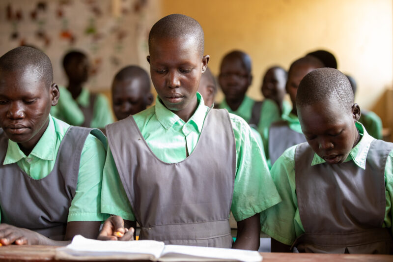 Happy to Be In School — Youn girls in South Sudan Africa are going back to school — Adult, Baby, Eyes Closed, Frontal Face, Group
