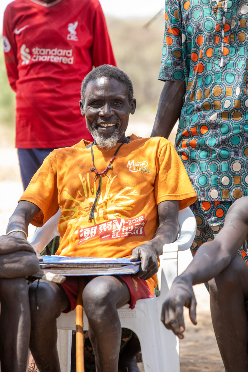 Adult Education — Adults under a tree gather for education on health, food security and income generation. — Adult, Beard, Eyes Open, Frontal Face, Male