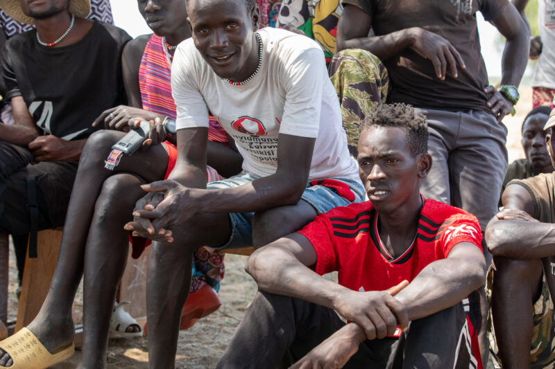 Adult Education — Adults under a tree gather for education on health, food security and income generation. — Adult, Athletics, Beard, Boat, Eyes Closed