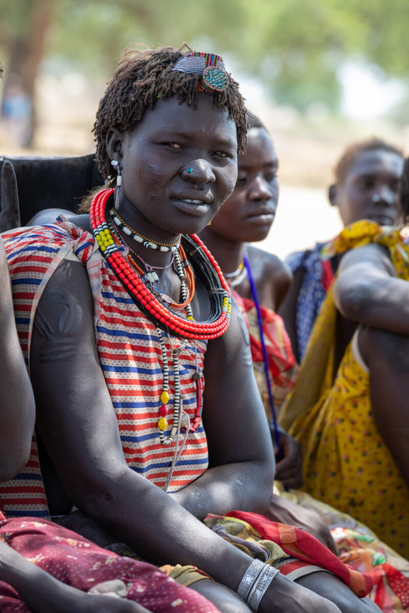 Adult Education — Adults under a tree gather for education on health, food security and income generation. — Eyes Open, Frontal Face, Male, One Face, Person