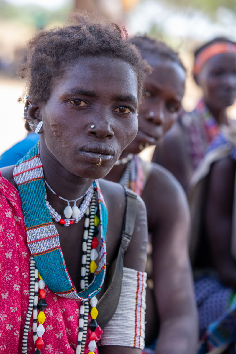Adult Education — Adults under a tree gather for education on health, food security and income generation. — Adult, Eyes Open, Frontal Face, One Face, Person