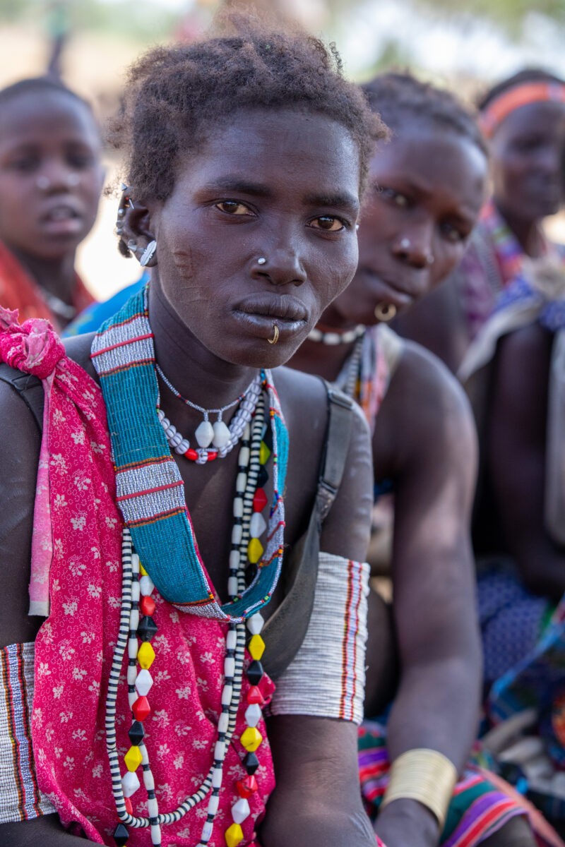 Adult Education — Adults under a tree gather for education on health, food security and income generation. — Adult, Child, Eyes Open, Female, Frontal Face