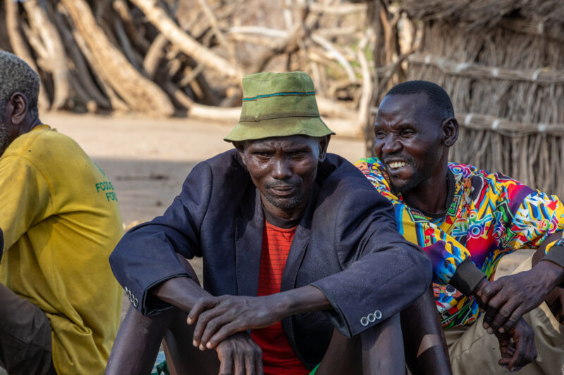 Men In South Sudan — Men of a rural village in South Sudan meet for the weekly meeting of a Savings and Loans group. — Adult, Beard, Eyes Open, Frontal Face,...