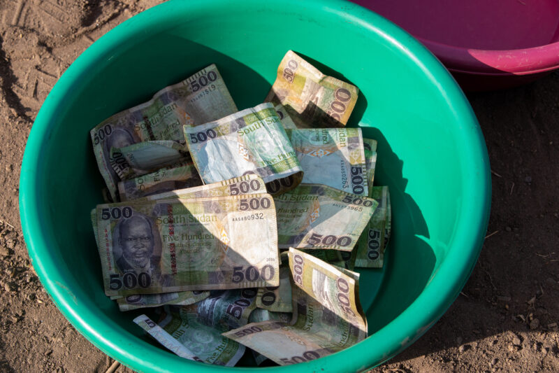 Collection Bowls — Bowl filled with the weekly fees for a Savings and Loans group in a village in South Sudan.. — Banknote, Africa, Pastoralists, Ethnic, Rural