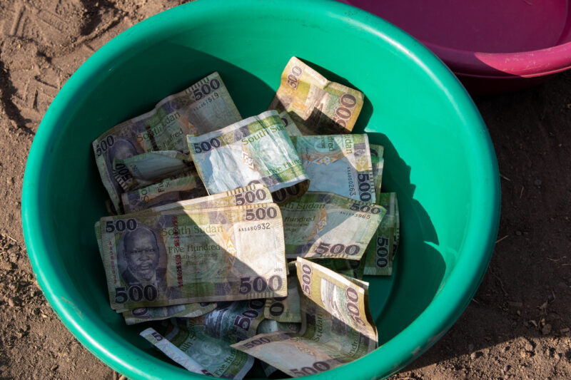 Collection Bowls — Bowl filled with the weekly fees for a Savings and Loans group in a village in South Sudan.. — Banknote, Africa, Pastoralists, Ethnic, Rural