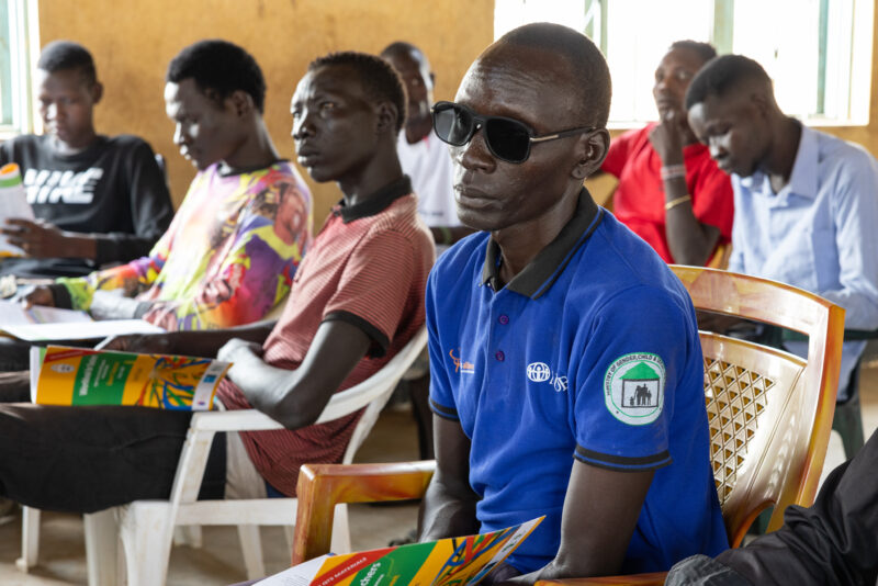 Teacher Training — Teachers go back to school to learn new methods of teaching in rural South Sudan. — Adult, Beard, Boat, Complementary Colors, Frontal Face