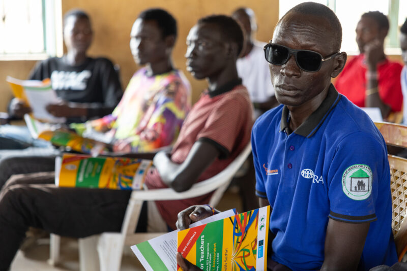 Teacher Training — Teachers go back to school to learn new methods of teaching in rural South Sudan. — Adult, Complementary Colors, Female, Frontal Face, Person