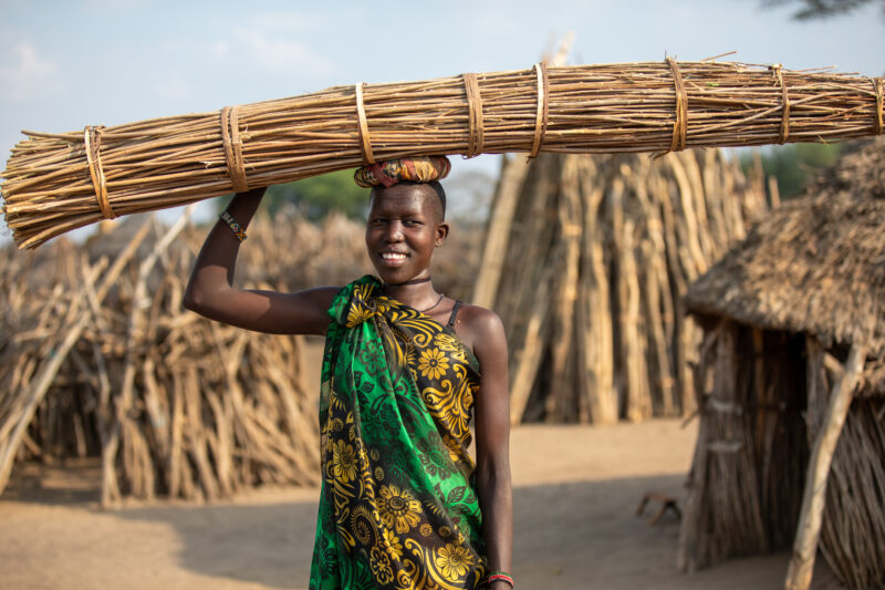 Girl with Reeds — Young girl in South Sudan, Africa with a bundle of reeds on her head — Adult, Eyes Open, Frontal Face, Male, One Face