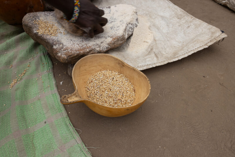 Grinding Grain — To make food easier to cook, it needs to be ground into flour — Food, Rice, Sepia Tones, South Sudan, Africa