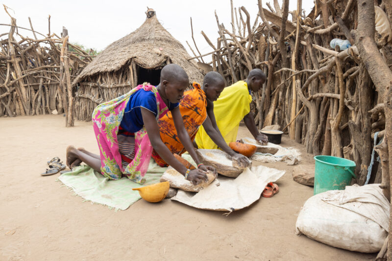 Grinding Grain — To make food easier to cook, it needs to be ground into flour — One Face, Person, Profile Face, South Sudan, Africa