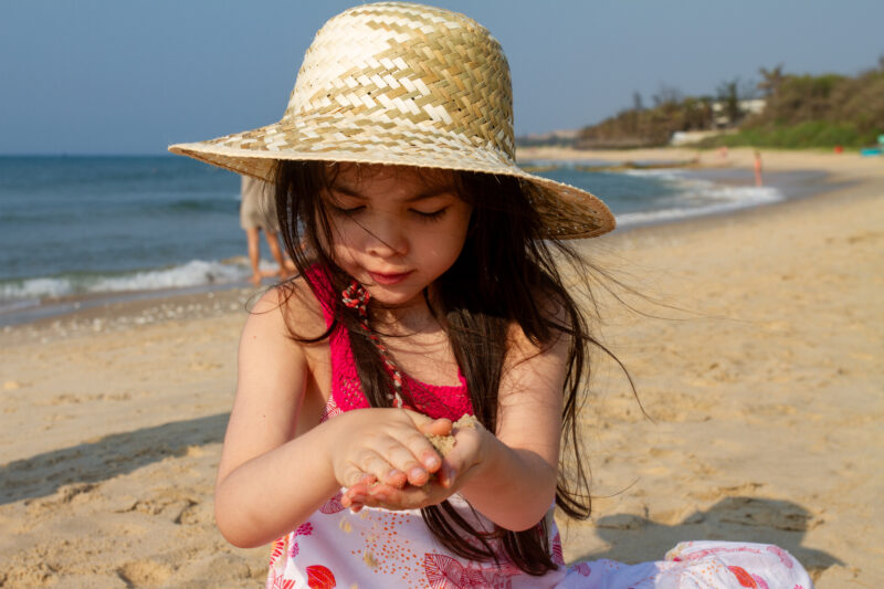 Girl at the Beach — Young girl plays on the beach in Vietnam — Beach, Child, Complementary Colors, Eyes Closed, Female