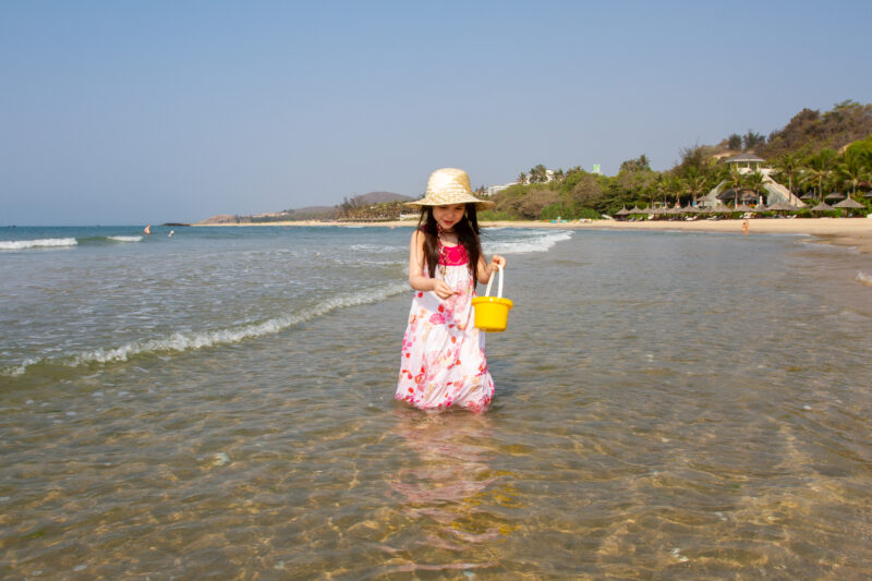 Girl at the Beach — Young girl plays on the beach in Vietnam — Beach, Child, Eyes Closed, Female, Frontal Face