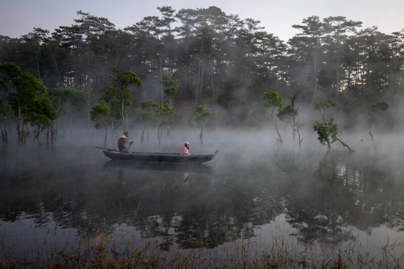 Early Morning on the Lake — Fog and mist rise up from a Lake in Vietnam making a scenic splender with a man in his fishing boat. — Boat, Canoe, Nature, River...