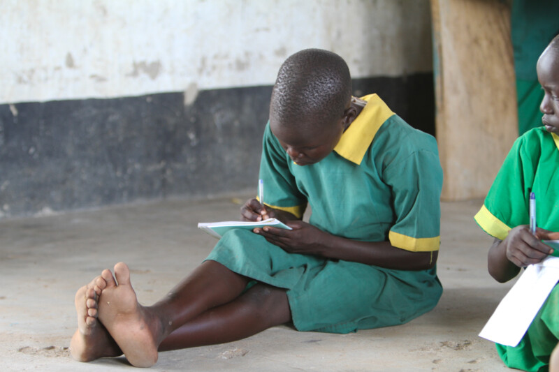 Girl Sits on Floor at School