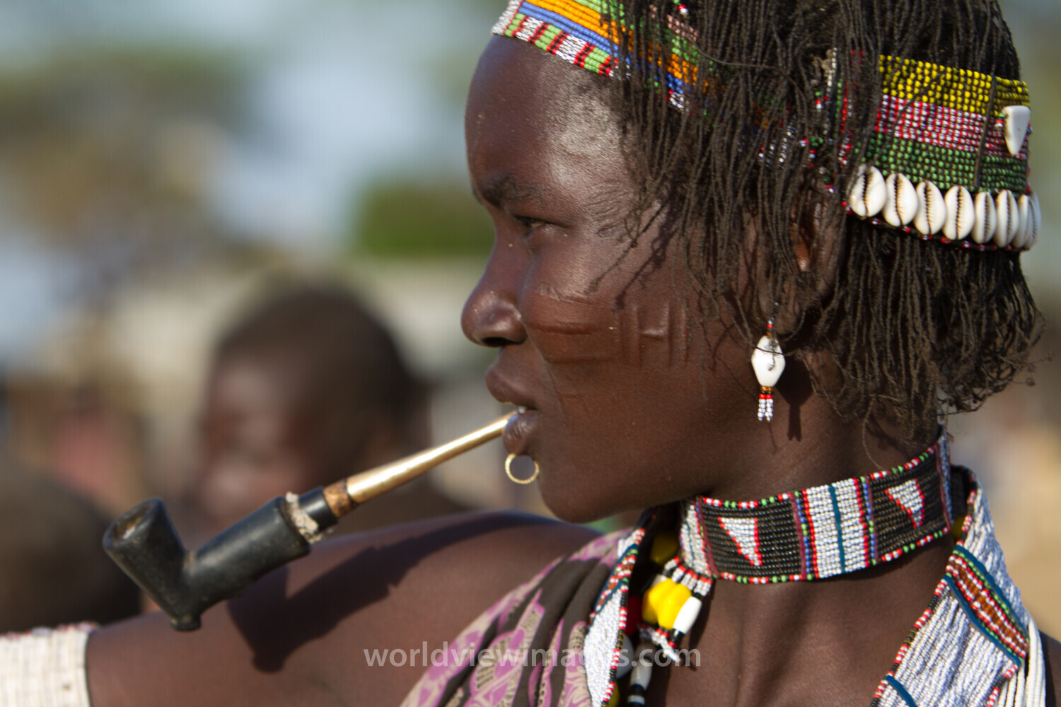Profile of Girl in South Sudan Smoking A Pipe
