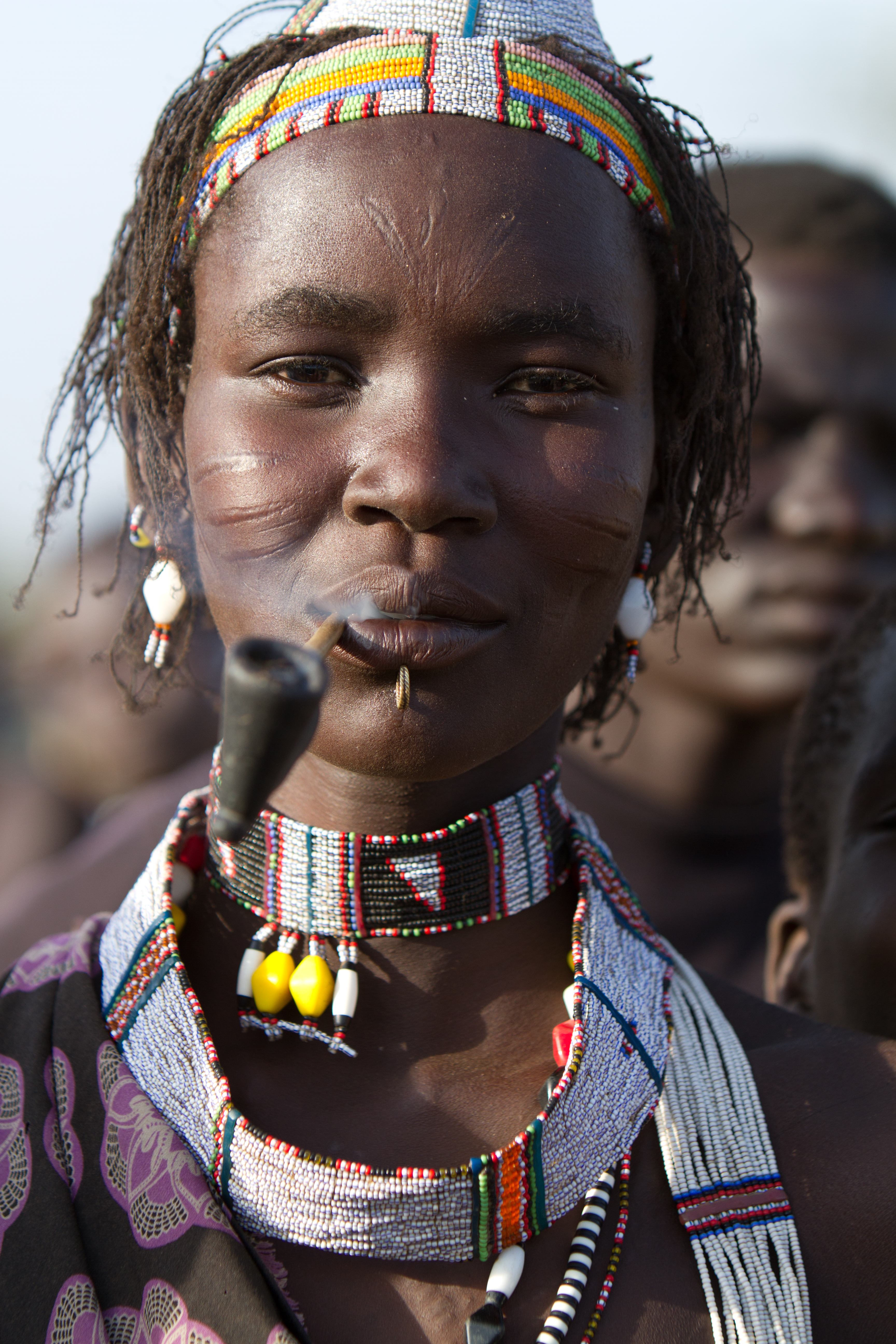 Woman in South Sudan Smoking A Handmade Pipe