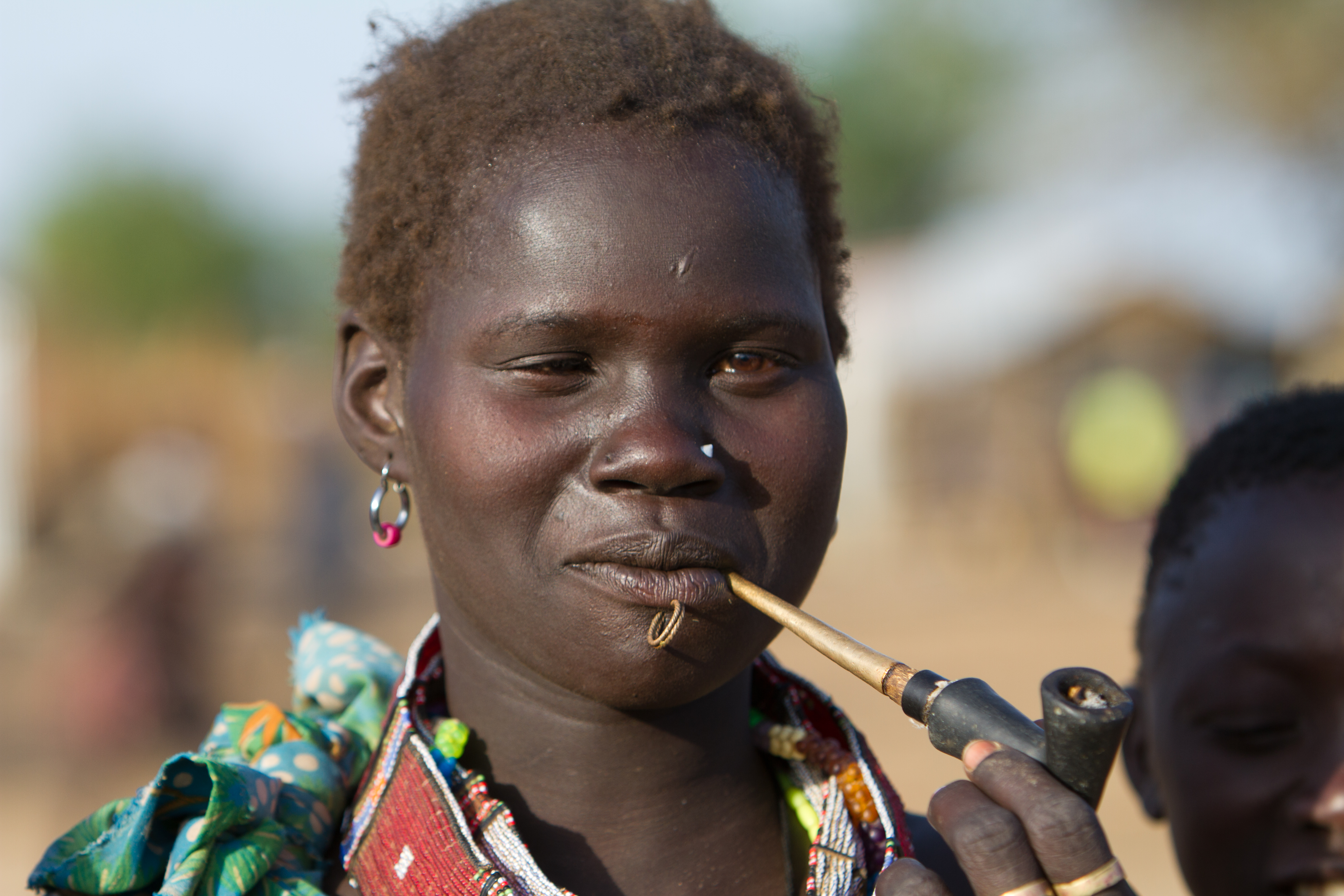Woman in South Sudan Smoking A Handmade Pipe