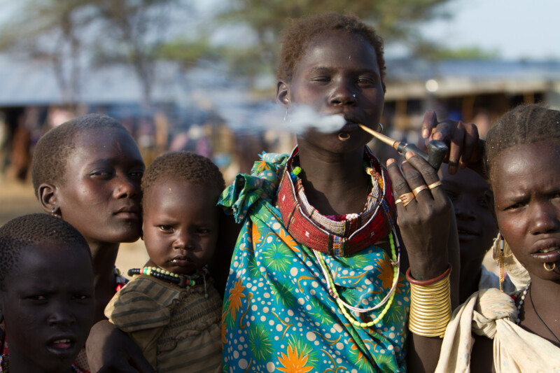 Woman in South Sudan Smoking A Handmade Pipe
